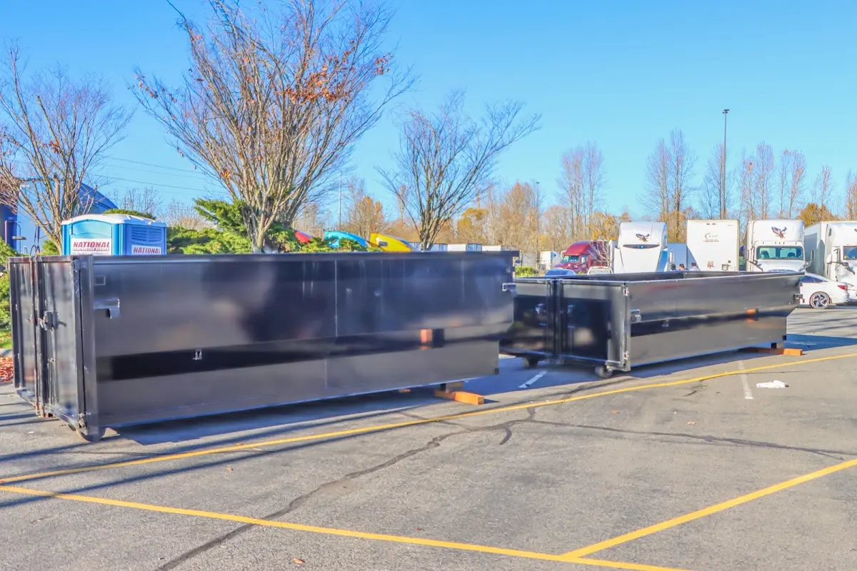 Professional dumpster rental service with roll-off container on residential driveway in District Heights